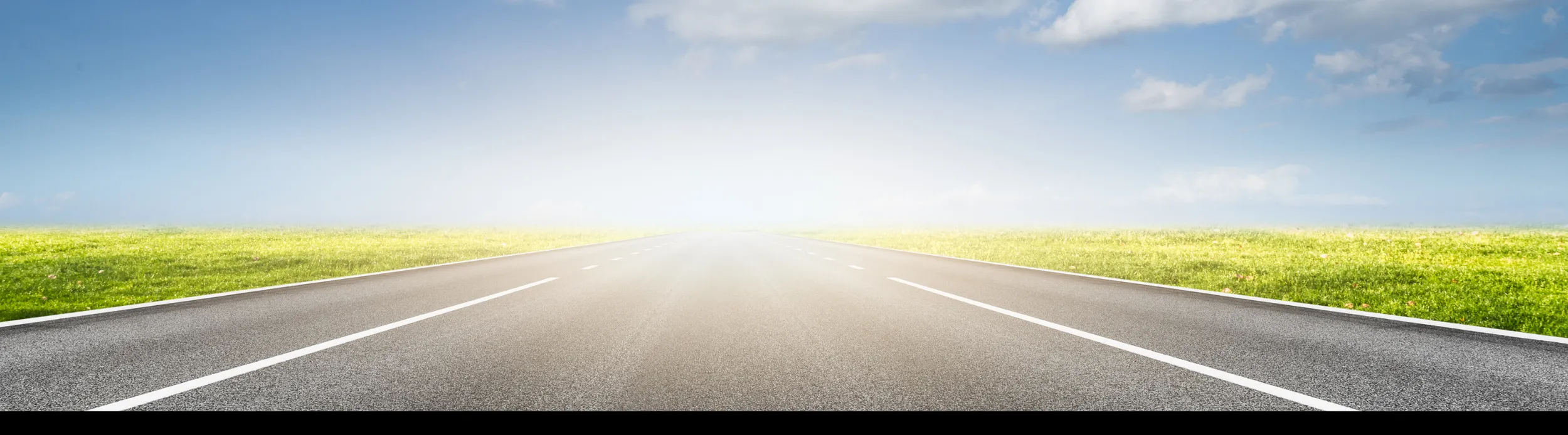 Open highway under a bright Louisiana sky
